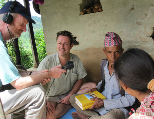 Returning a copy of my grammar of the Thangmi language to my language teacher and his daughter,: witnessed by the BBC, Cokati, Nepal Photograph by Hikmat Khadka, August 2012